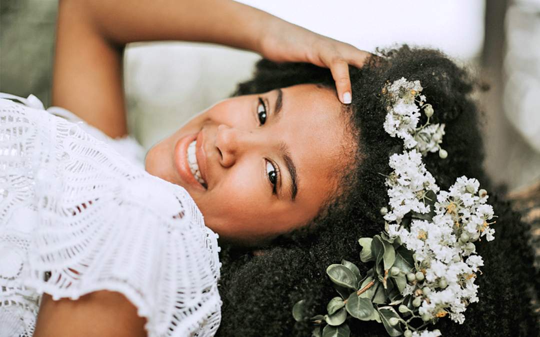 Happy bride with white flowers in her hair.