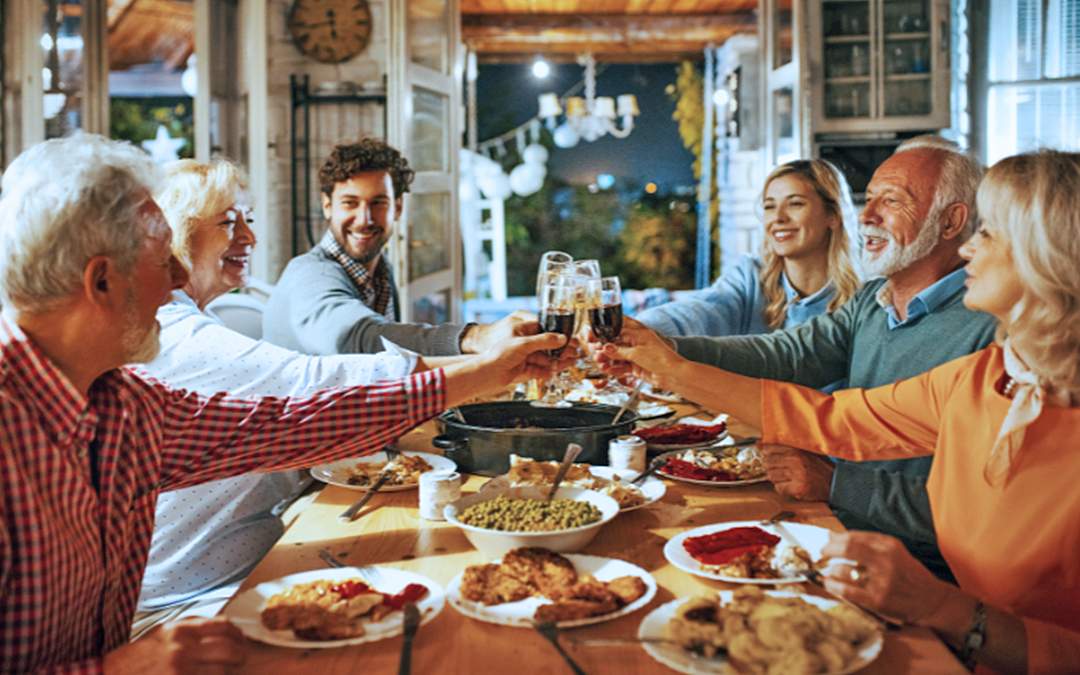 Newly engaged couple enjoying Thanksgiving meal with family.